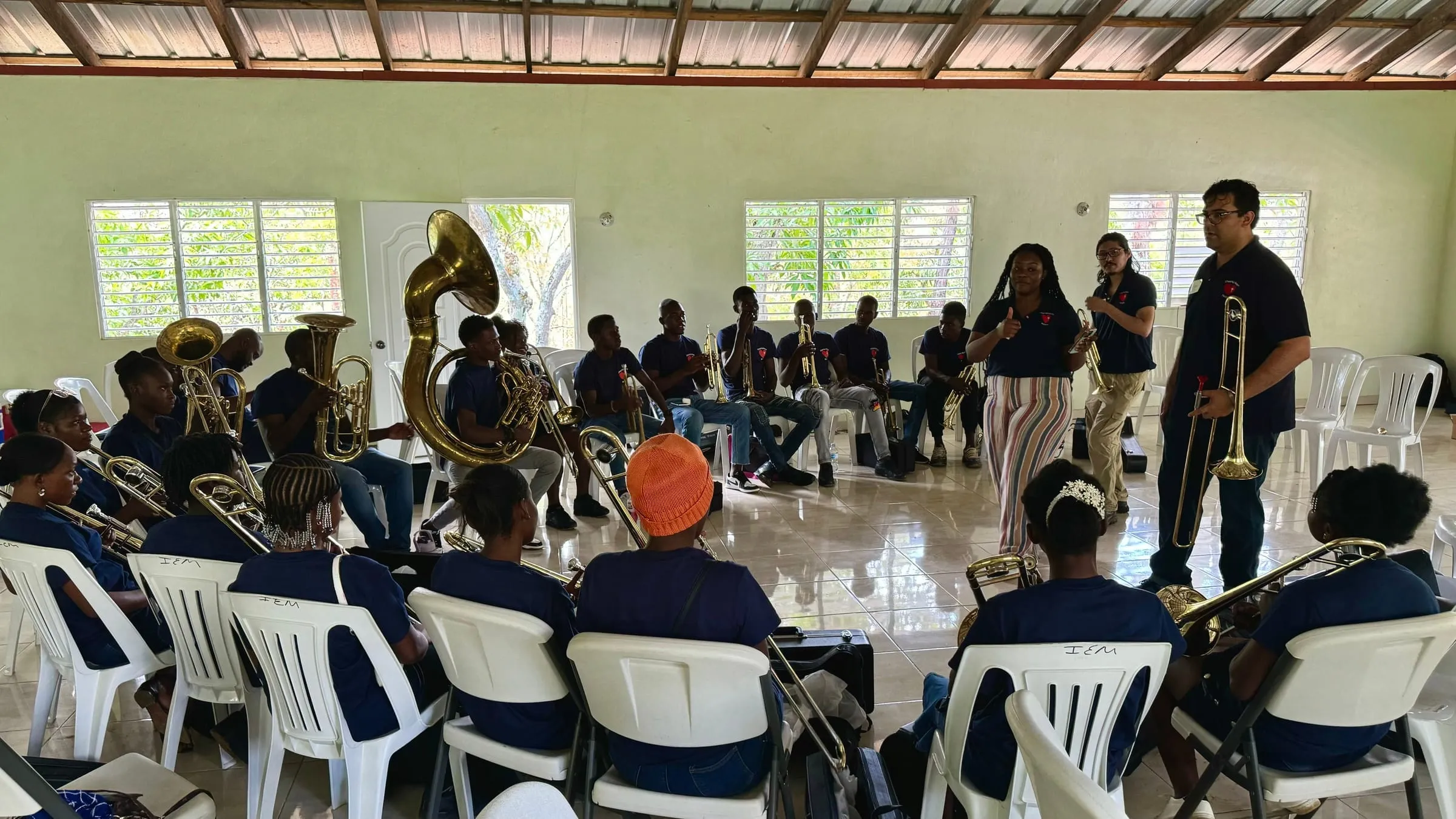 A brass band class gathered in a circle