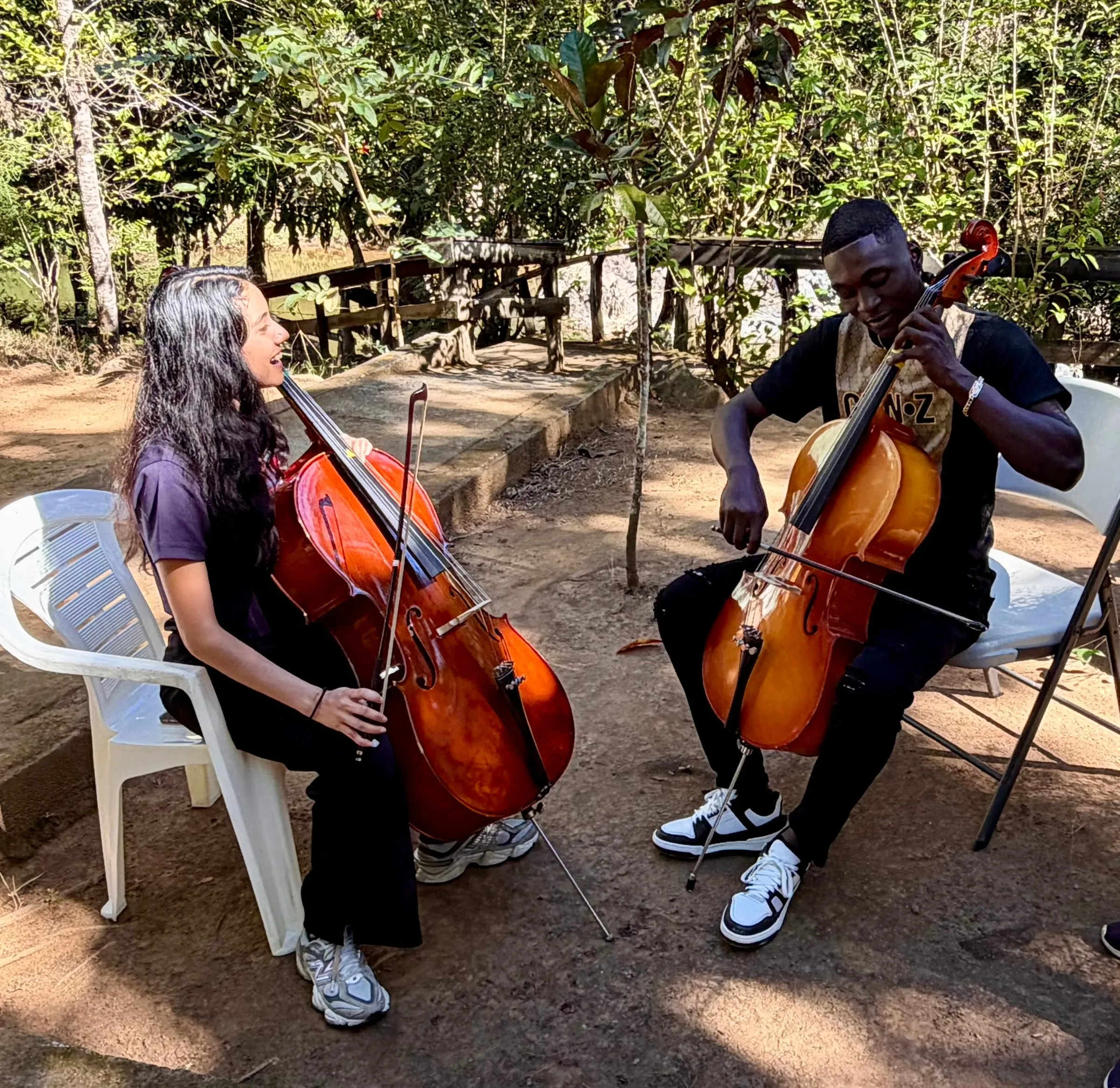 A cello duet performed outdoors