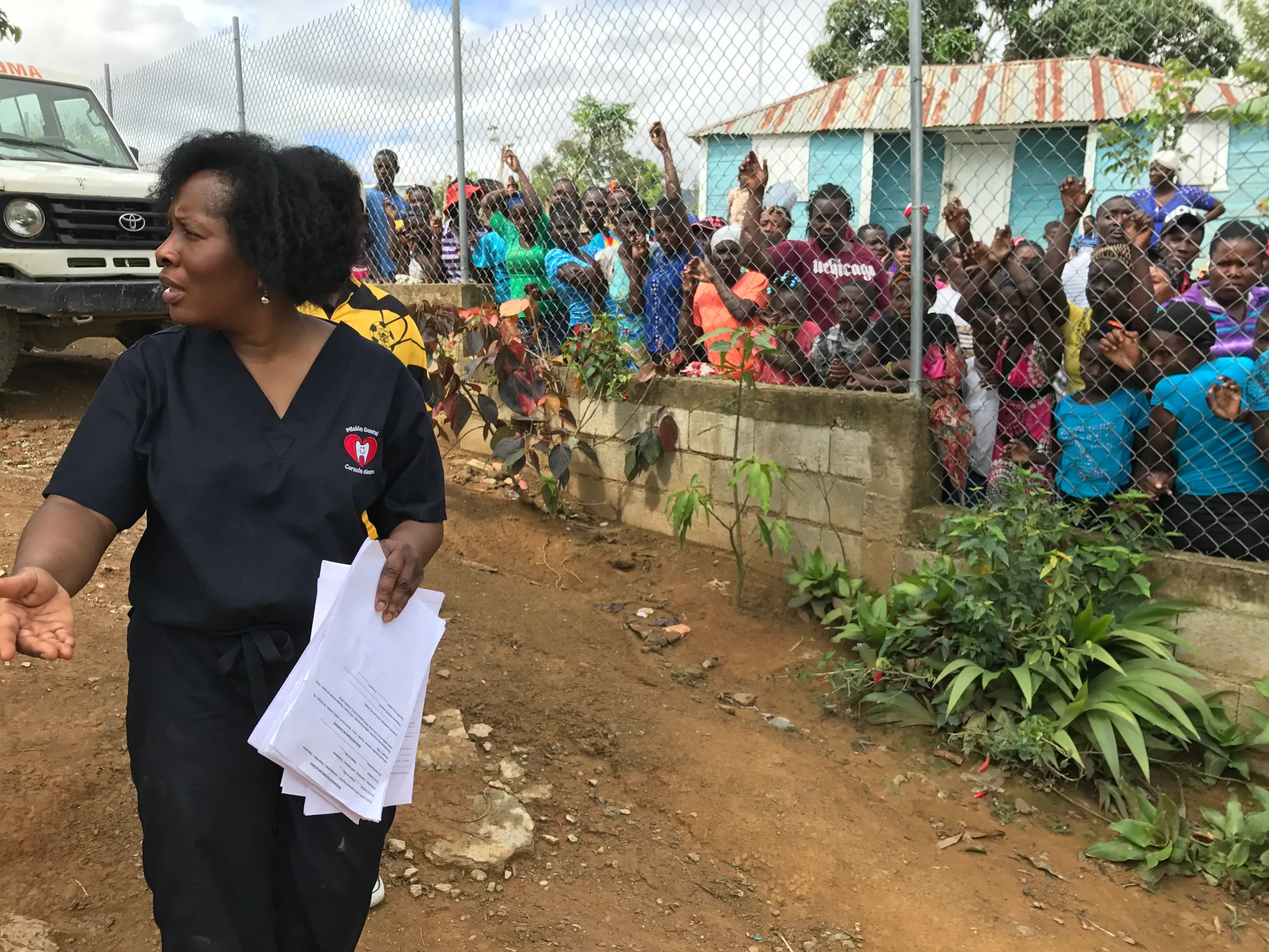 A mission coordinator organizes the crowd waiting for care