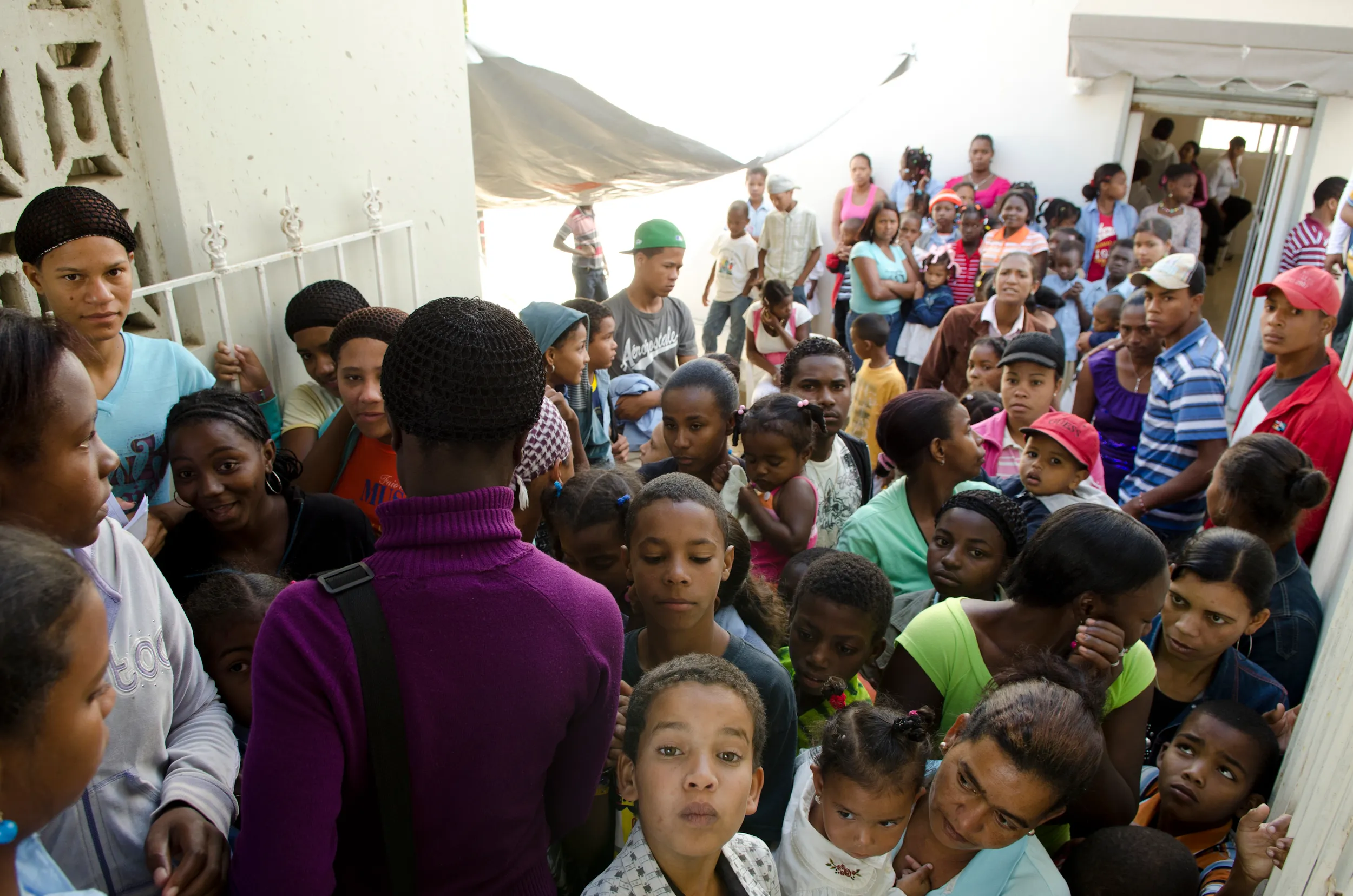 Patients wait at the clinic door for free dental care