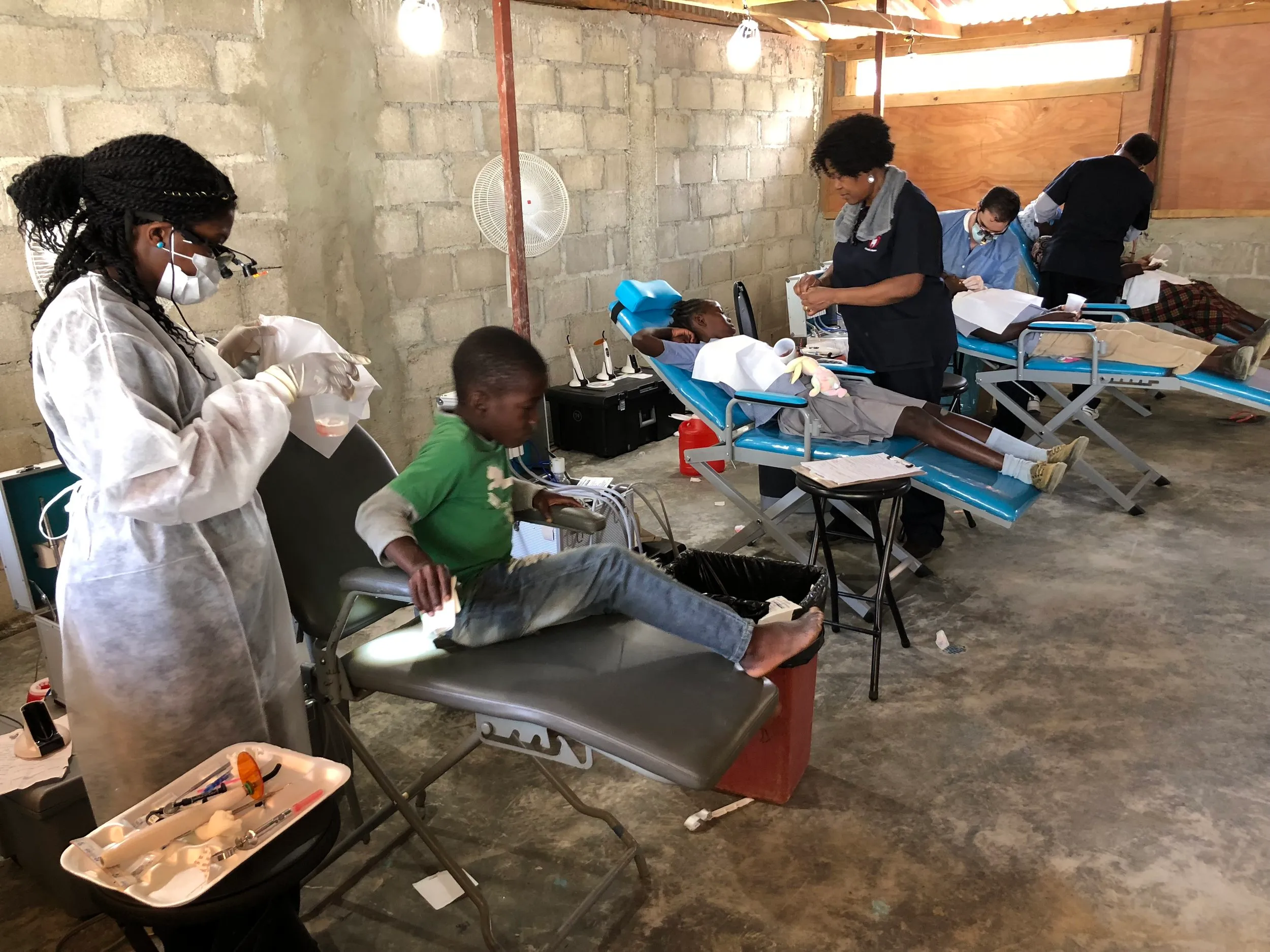 Portable dental chairs fill the clinic room