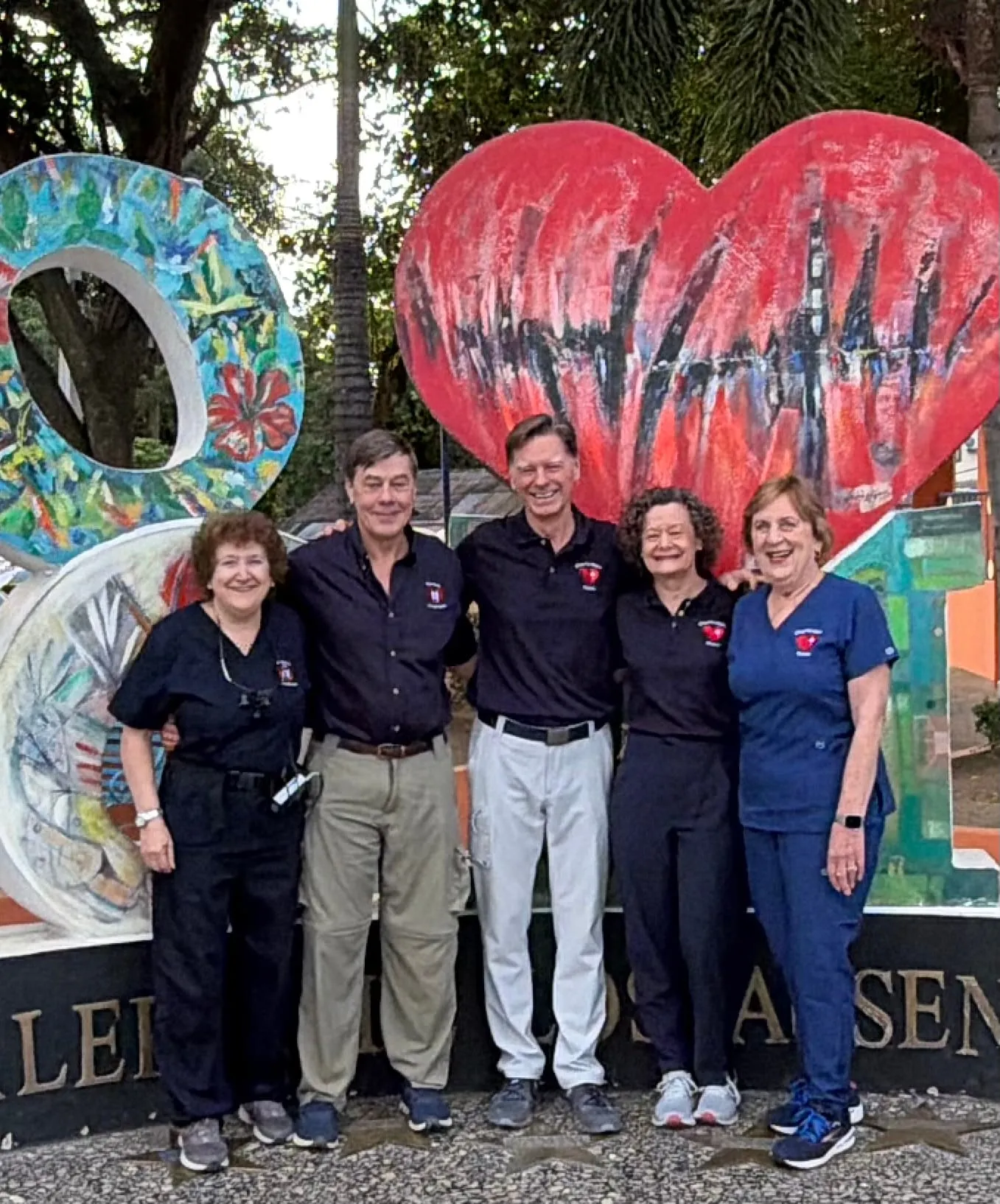 The dental mission team at the Corazón Alegre heart mural