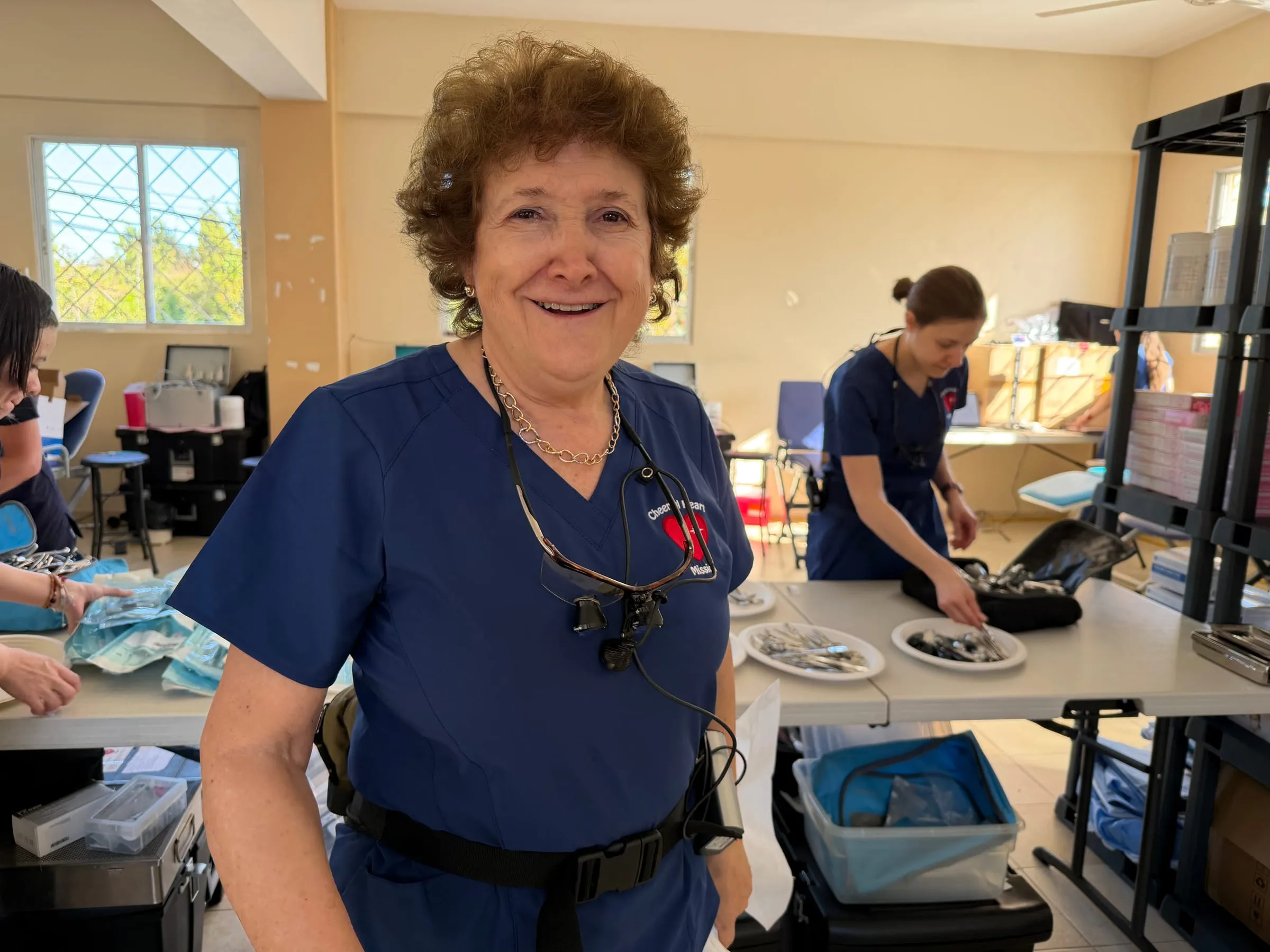 A volunteer readies the day's dental instruments