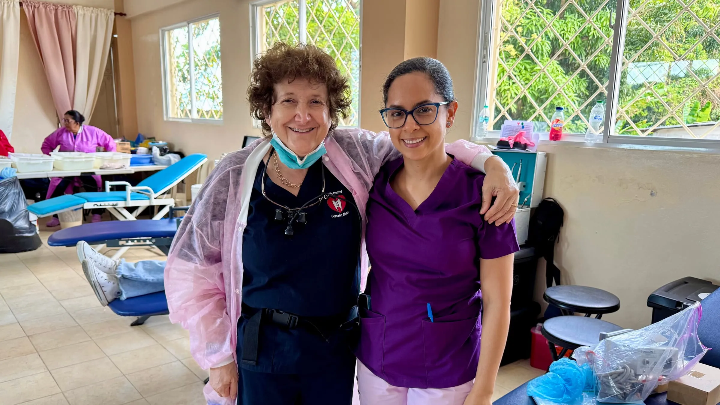A volunteer dentist with her local clinic assistant