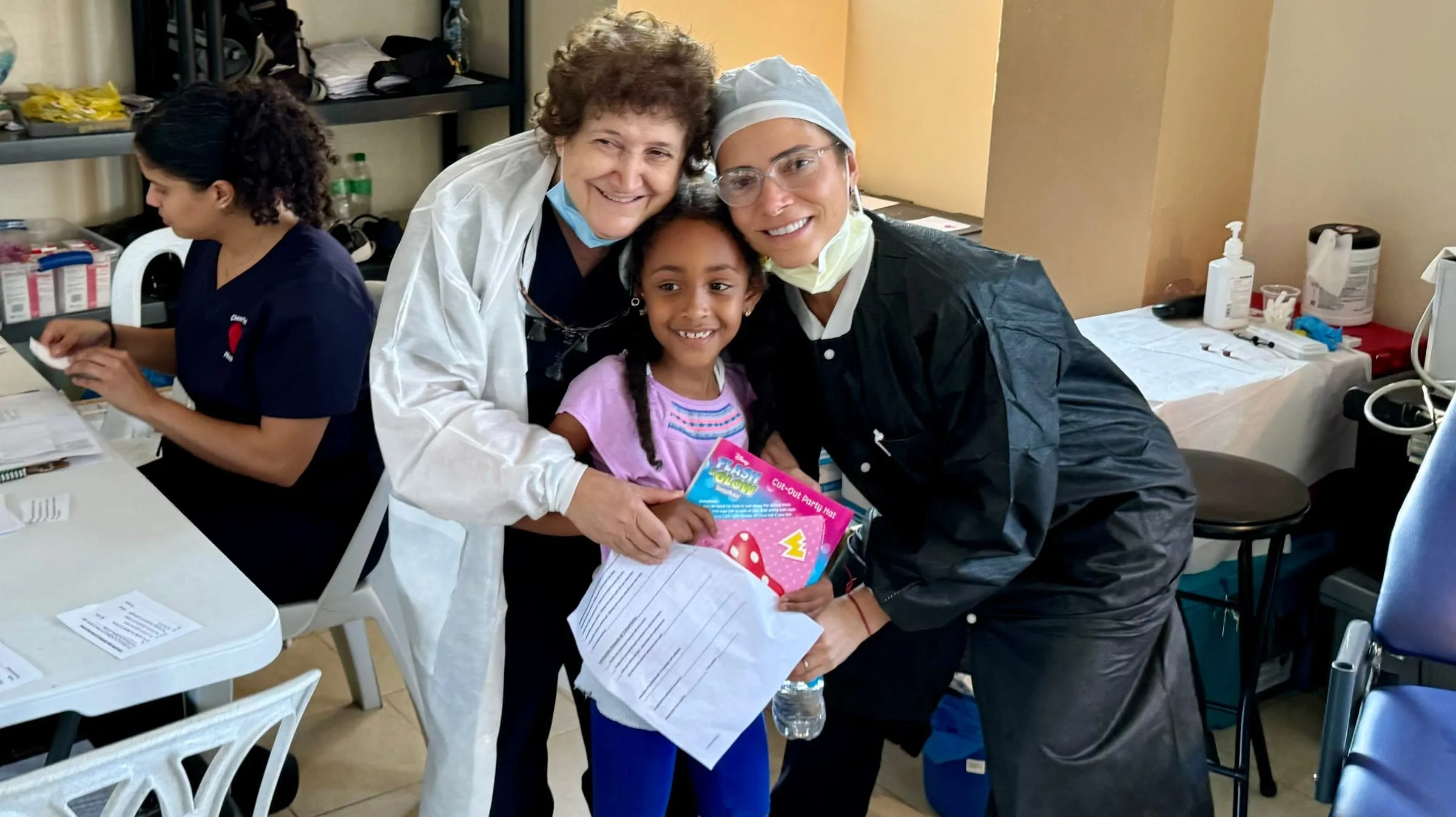 Volunteer dentists care for a young girl