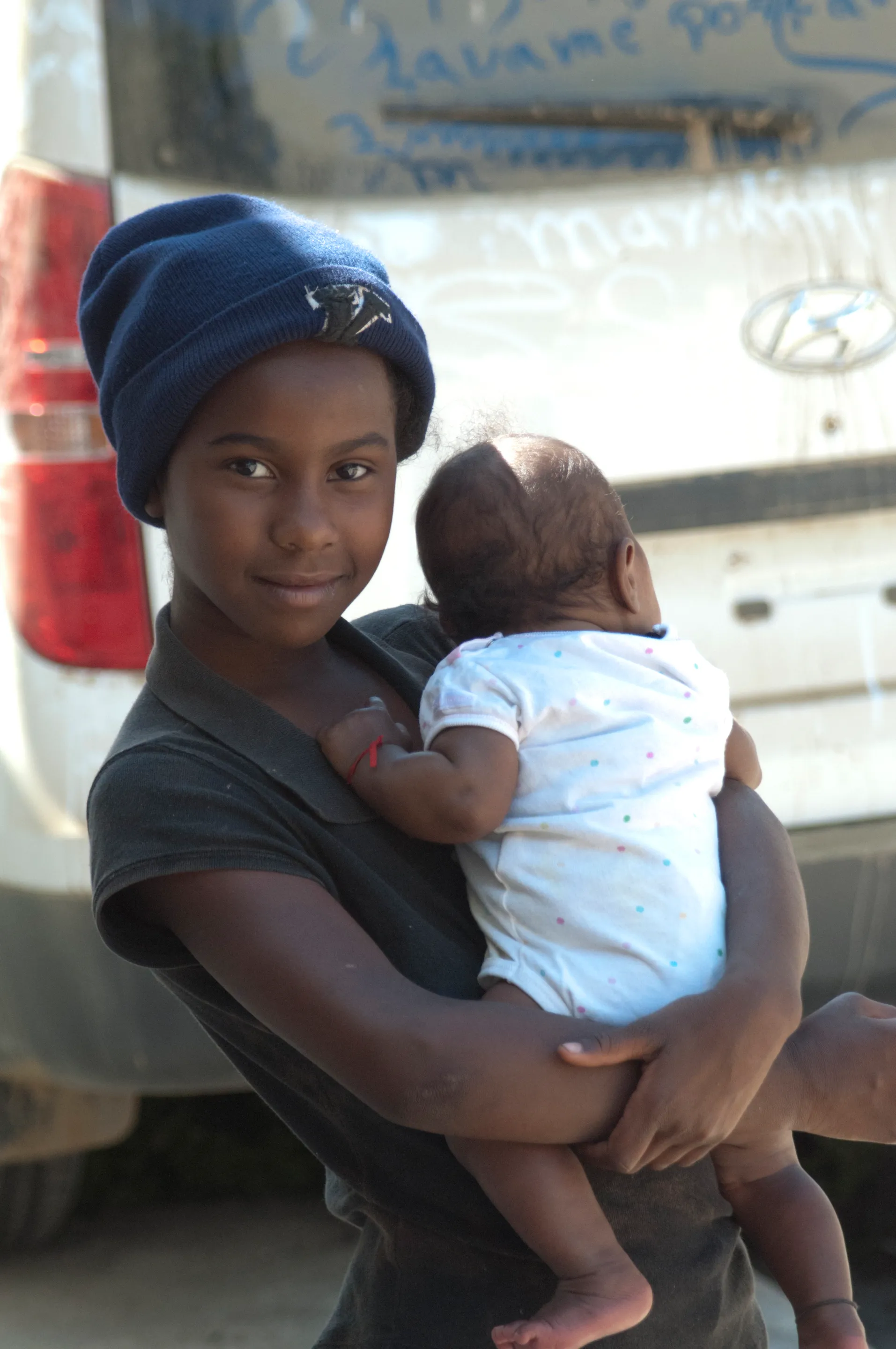 A girl and her baby sibling