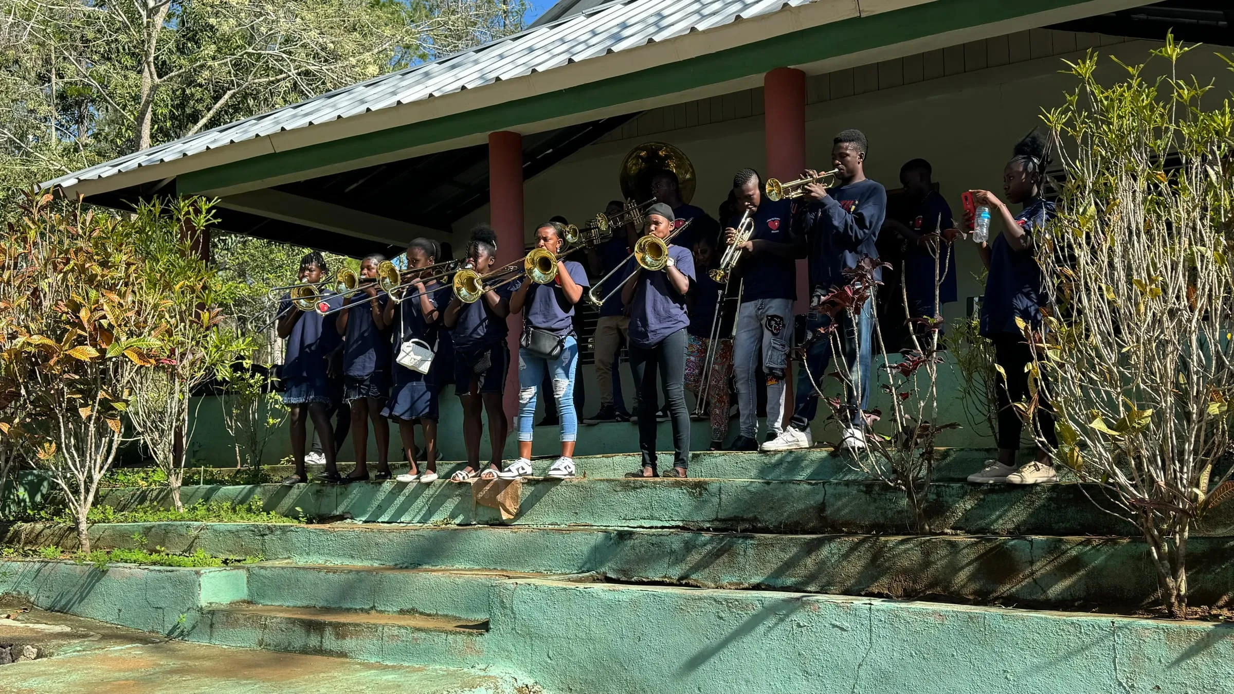 A student brass band plays outdoors