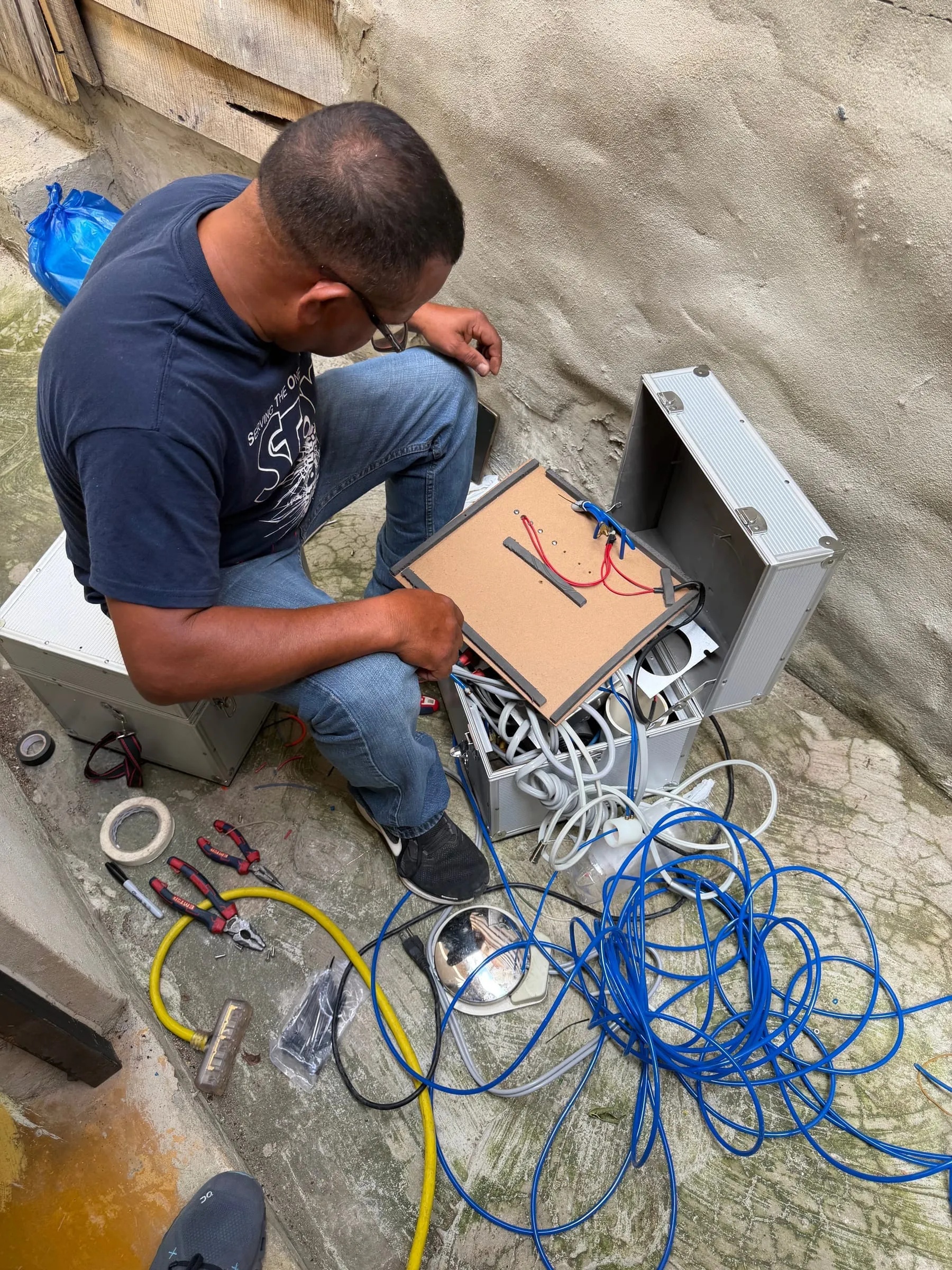 A technician repairs a portable dental unit