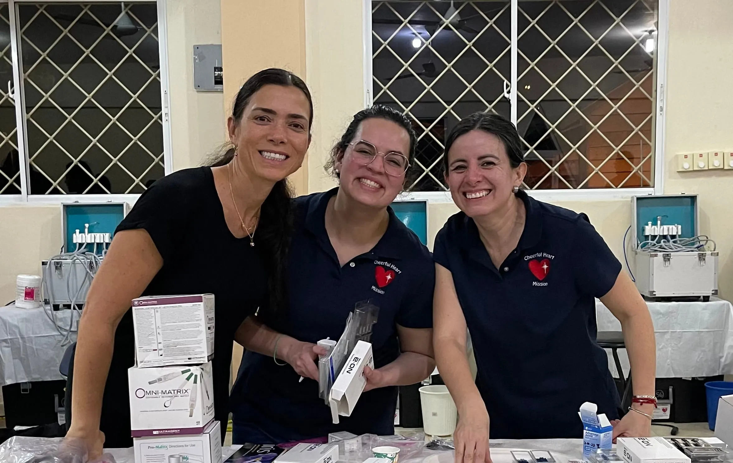 Volunteers organize dental supplies into the evening