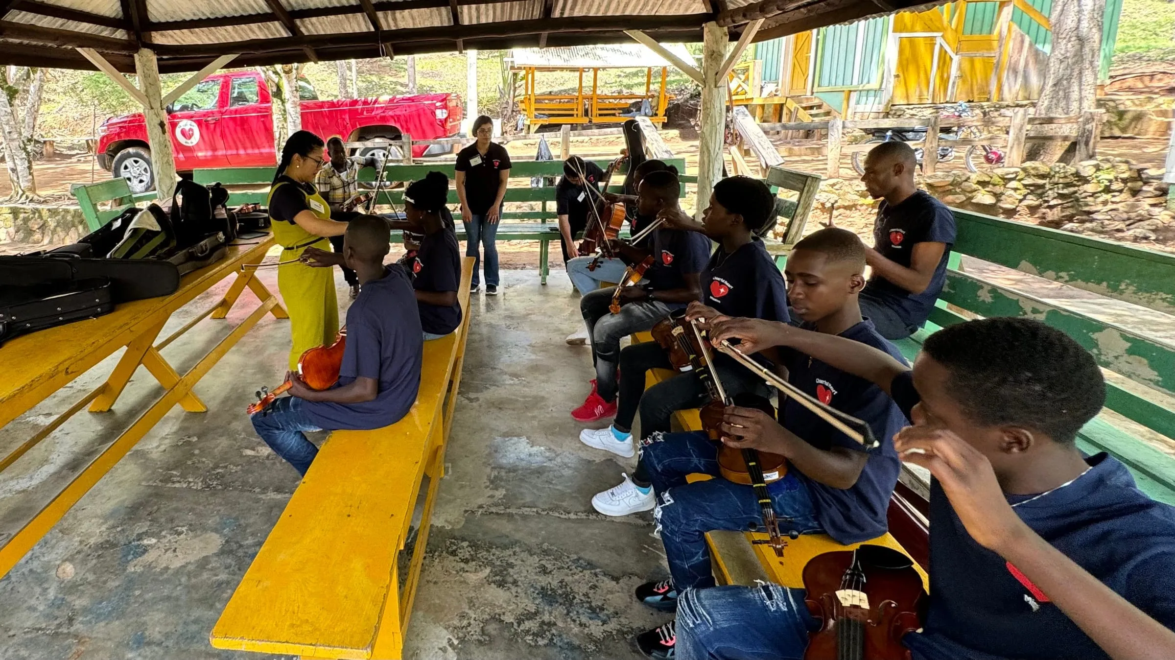 A violin lesson under a pavilion