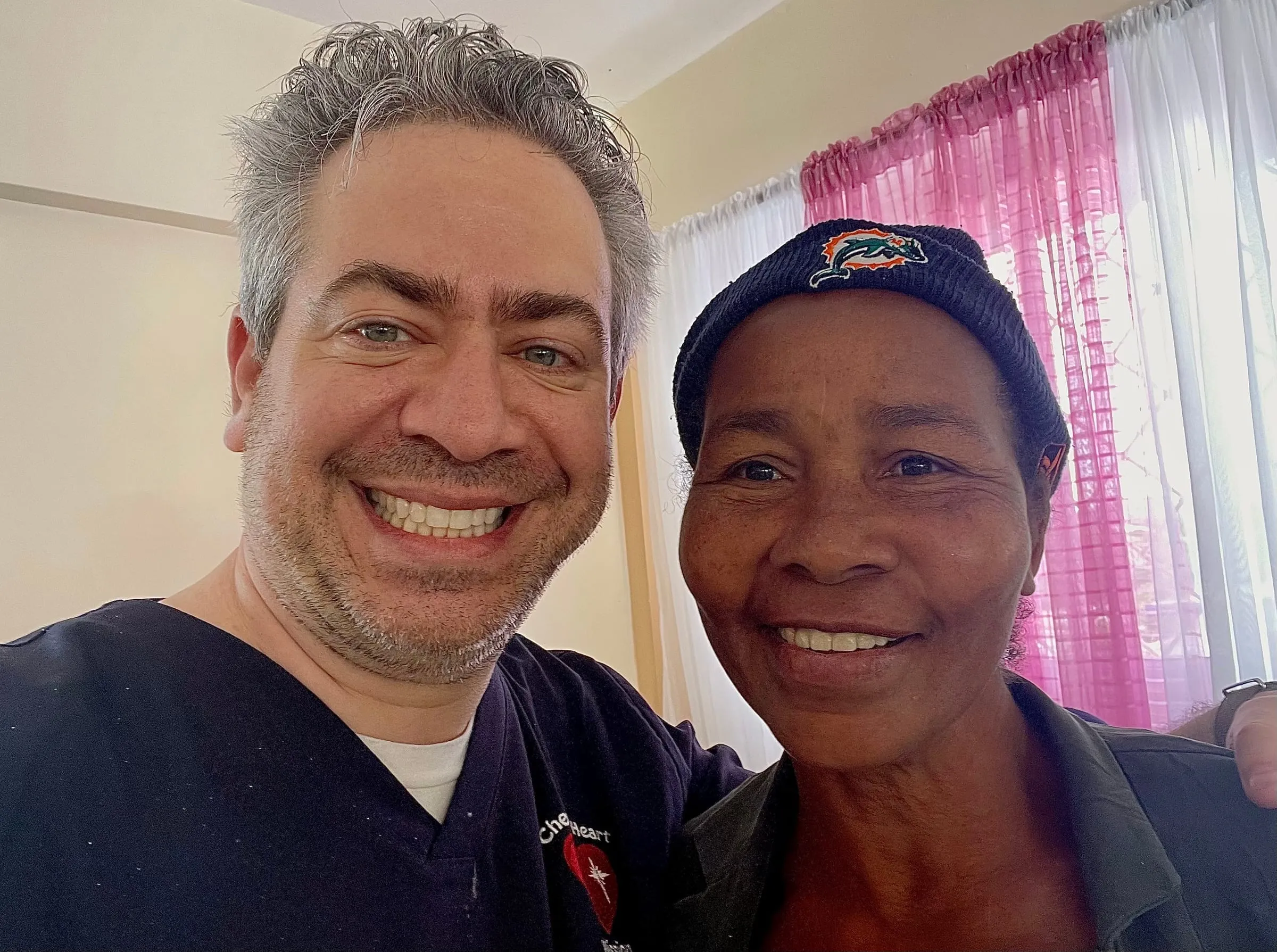 A volunteer takes a selfie with a patient